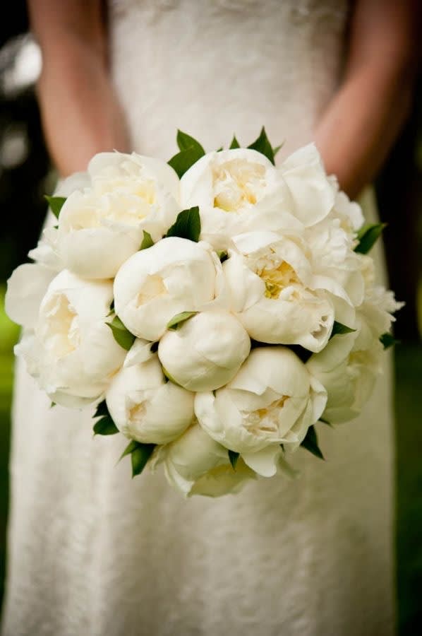 White bridal bouquet of peonies with green accents