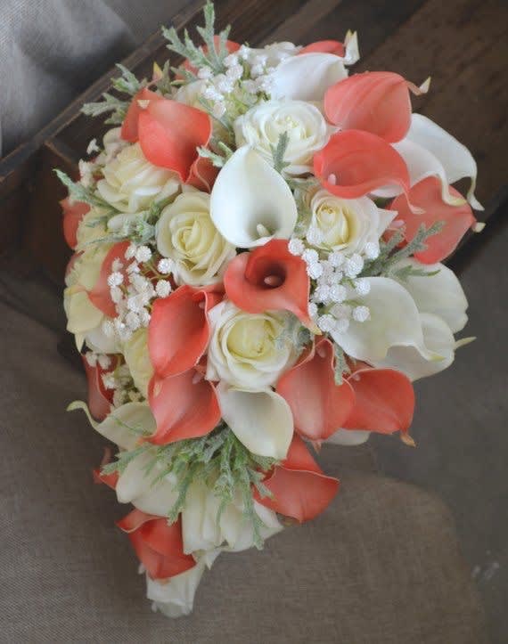 Bouquet of white roses and coral calla lilies