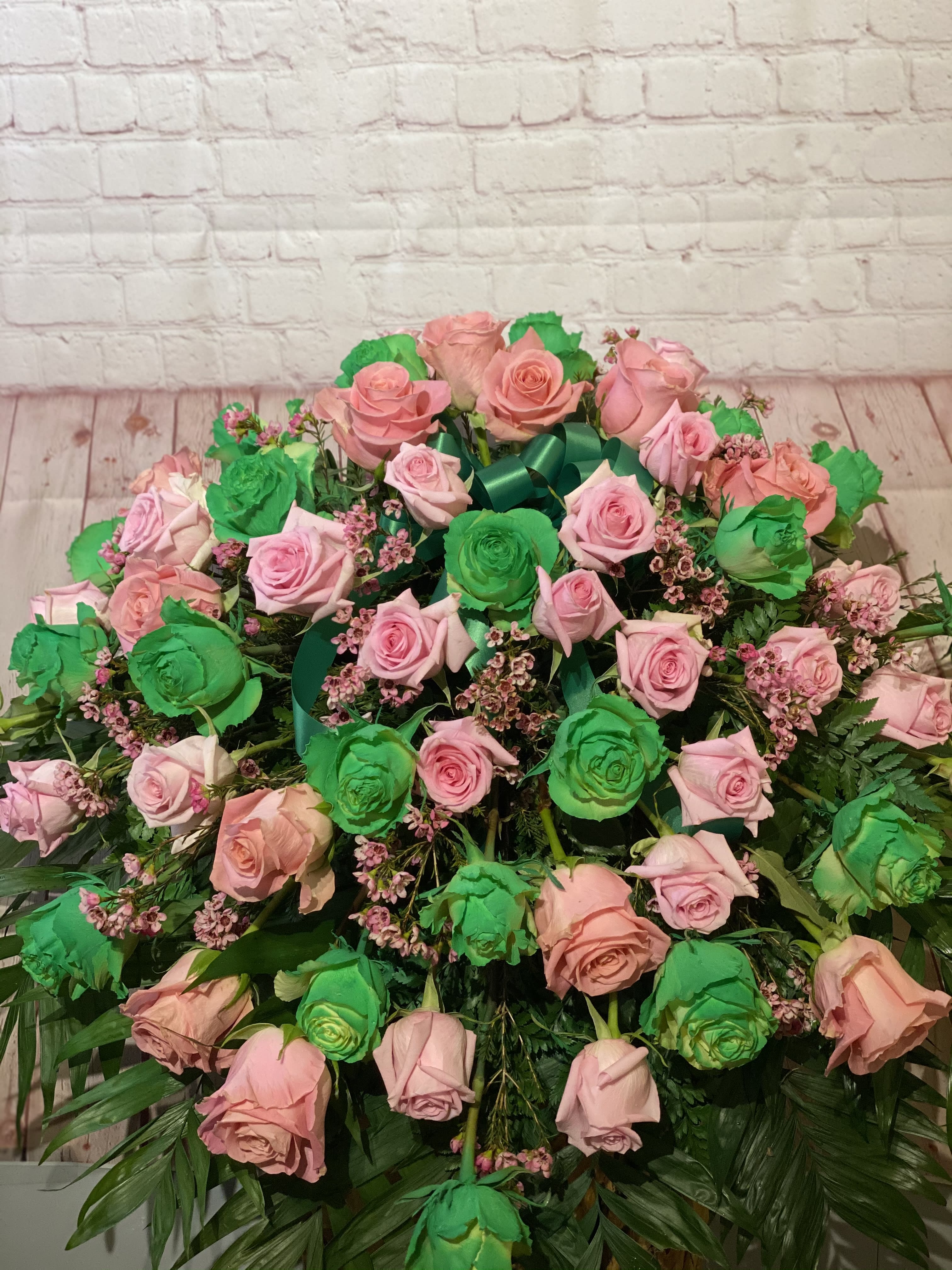 Large bouquet of pink and green roses with ribbon