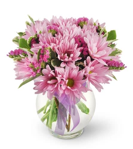 Pink daisy bouquet in a clear glass vase with a lavender ribbon
