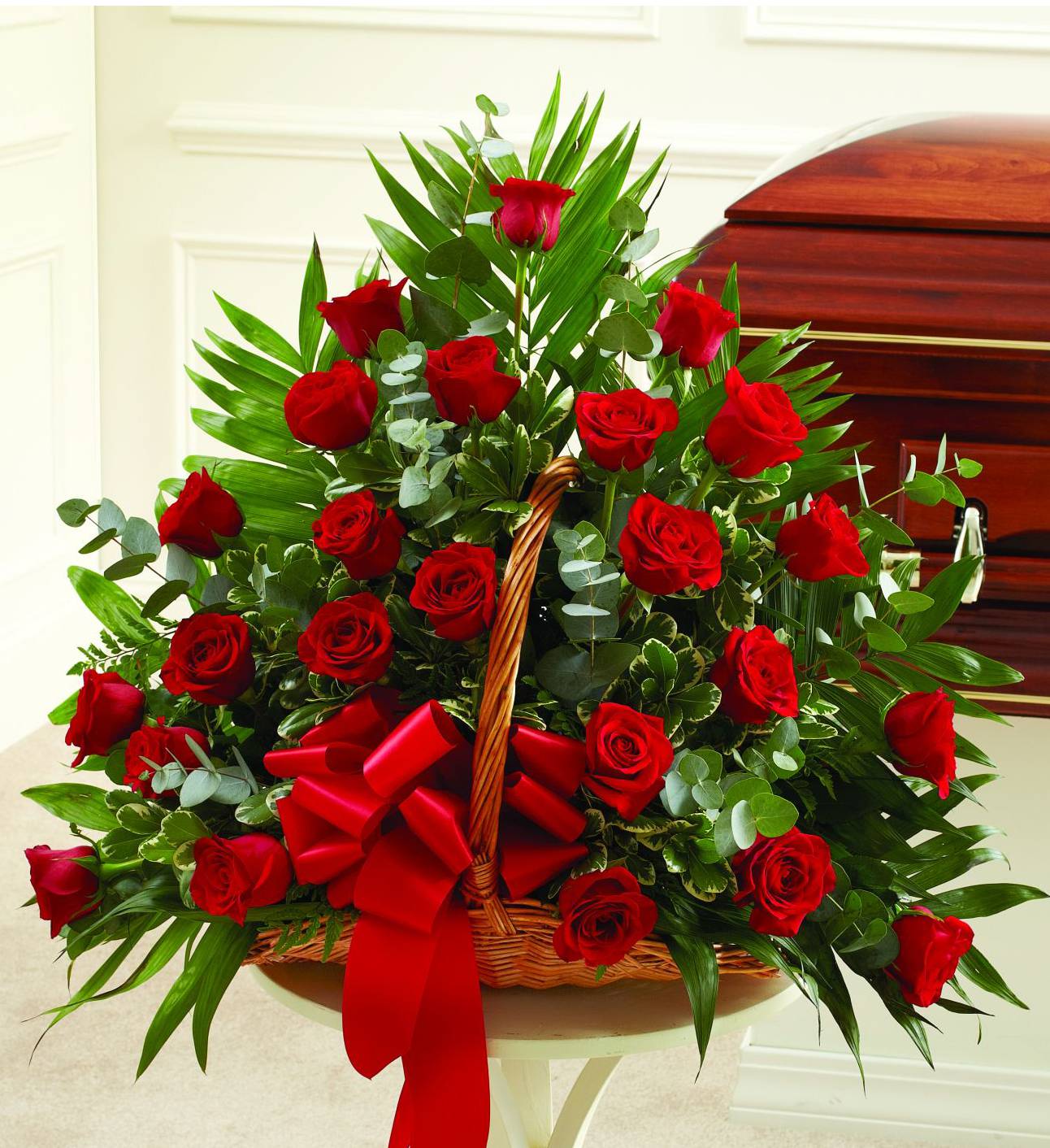 Basket arrangement of red roses with a red ribbon
