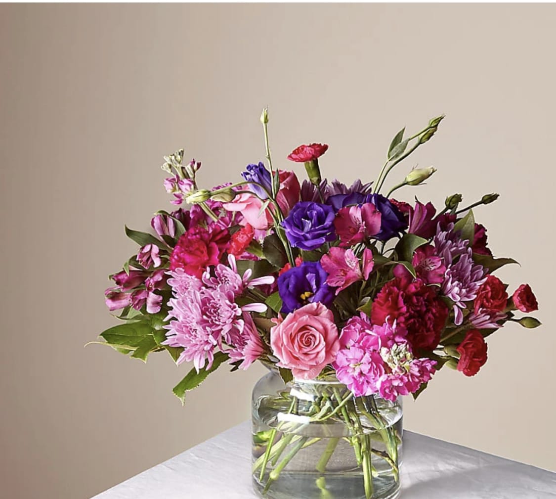 Mixed pink and purple bouquet in a clear glass vase