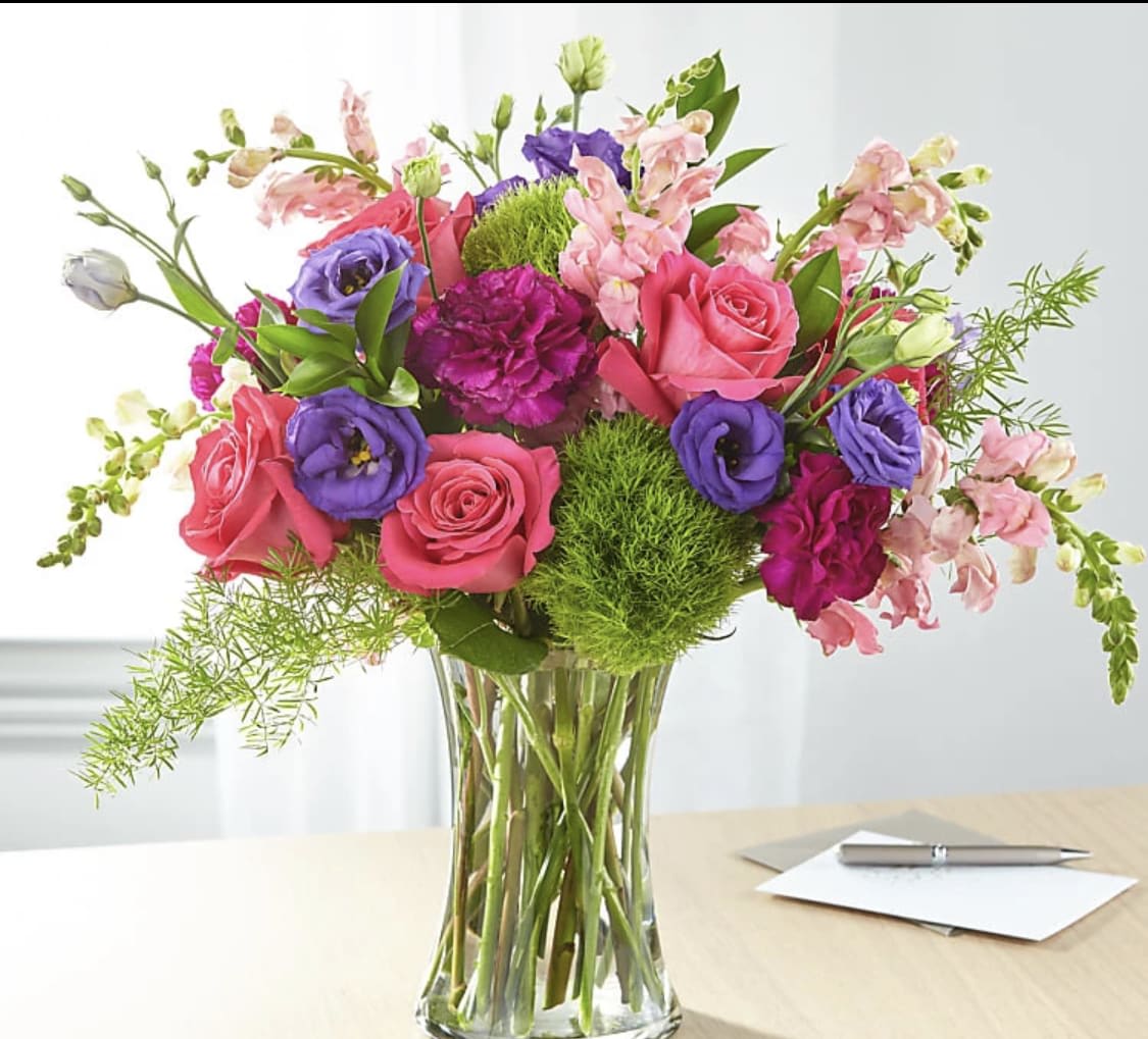Mixed pink and purple bouquet in a clear glass vase