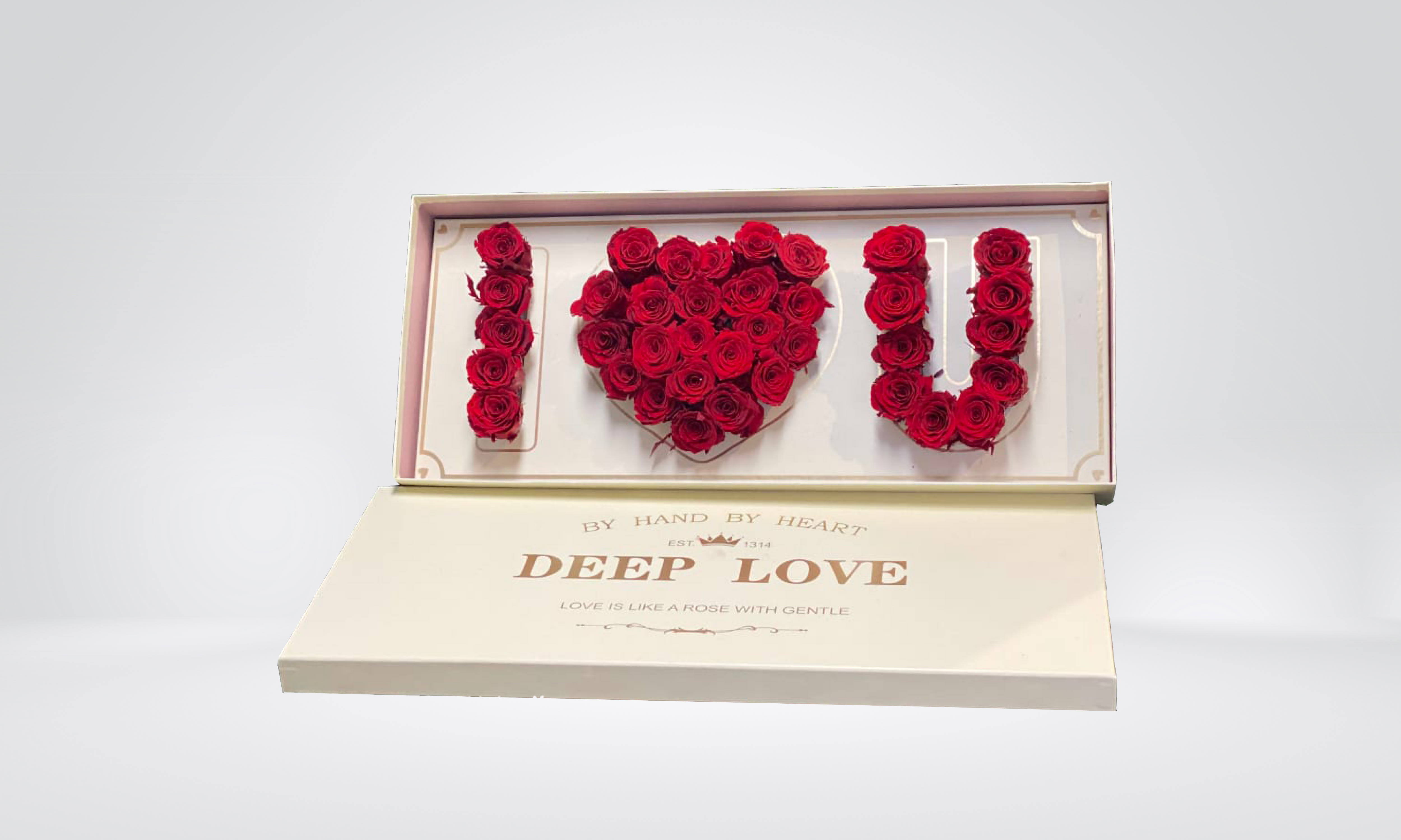 Red roses arranged to spell I love you in a gift box