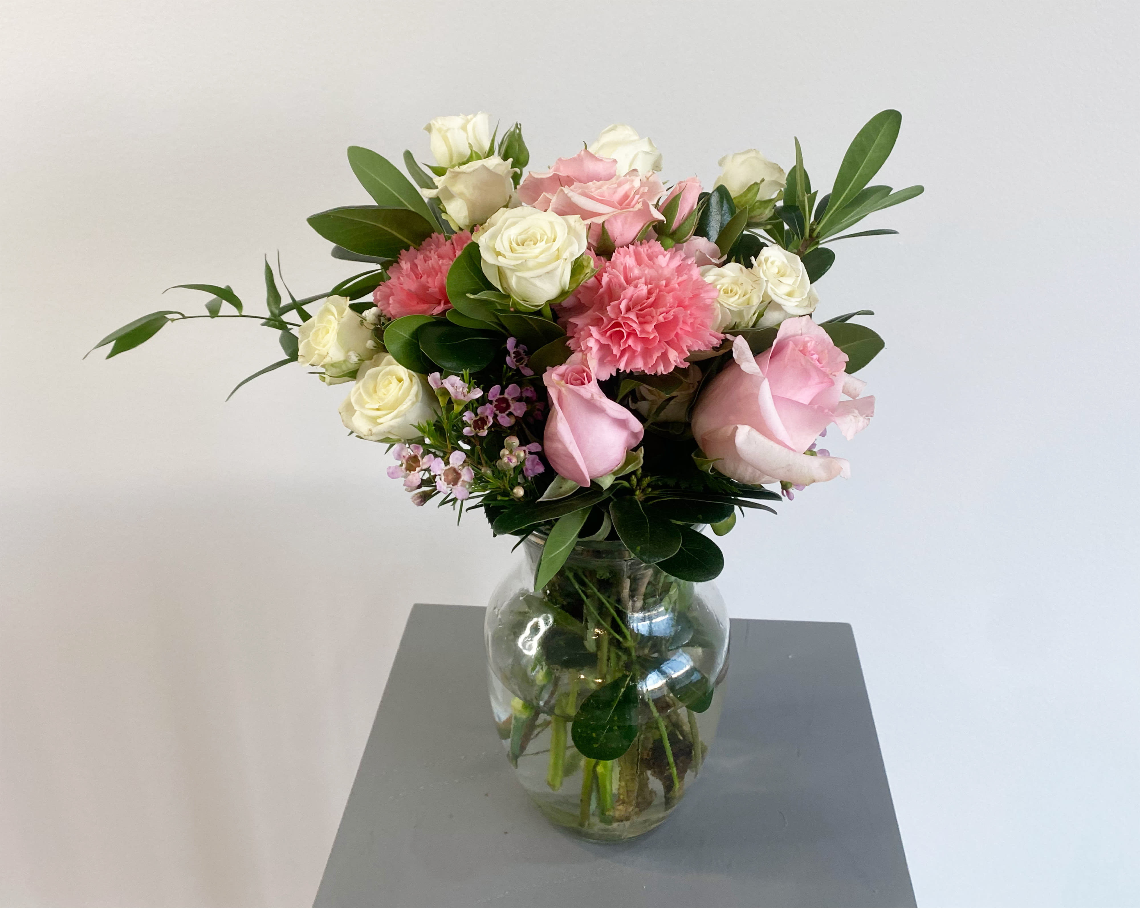 Sweet &amp; Subtle  - This arrangement includes pink roses, white roses, white spray roses, pink carnations, and dusty miller. Sweet &amp; Subtle by Leo's Florist is the perfect gift for a birthday, thank you, or just because.   APPROXIMATE DIMENSIONS: 9" H X 10" W