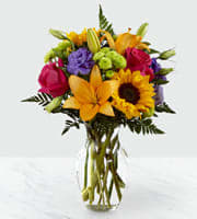 Bouquet of mixed flowers in a clear glass vase