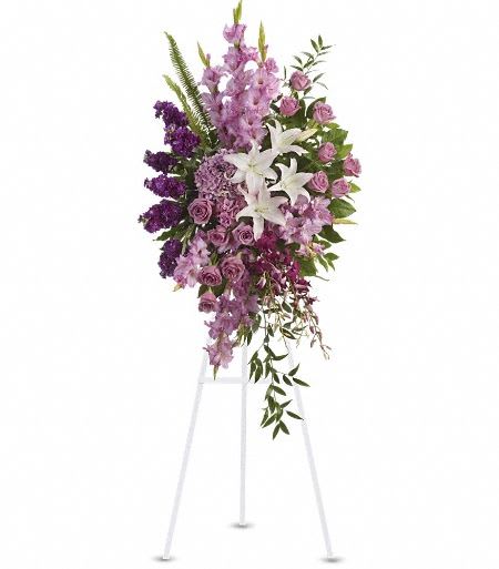 T249-4A Sacred Garden Spray - A lovely lavender spray of flowers lets you share your compassion, hope and beauty with all. Beautifully simple. Beautifully serene. It's the perfect way to send your sincere sympathy.  Lavender, purple and white flowers like hydrangea, orchids, roses, oriental lilies and more create a beautiful spray. A wonderful tribute. Approximately 26" W x 51" H  