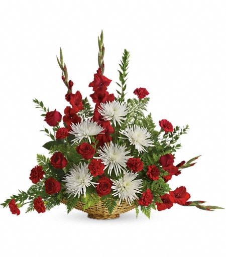T261-1A Enduring Grace - Everyone mourning the loss of a loved one will be comforted by this lovely array of red roses, red gladioli and white mums. A beautiful choice for the memorial service. The radiant bouquet includes red roses, red gladioli, red carnations and white spider chrysanthemums, accented with assorted greenery. Delivered in a 14" fireside basket. Approximately 36" W x 31" H 