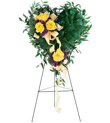 TF204-1  Friendship Rose Heart - This striking heart with its yellow roses expresses your friendship in a most memorable, heartfelt way. One foliage-covered heart on an easel arrives decorated with a cluster of yellow roses and purple statice accented with pink ribbons. Approximately 19" W x 22" H 