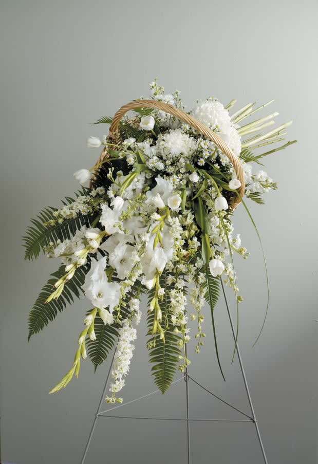 Garden Gathered Basket Standing Spray - Cherish the life of a loved one with an expressive spray that will express their elegant spirit and bring beautiful comfort to the friends and family who are grieving. The Garden Gathered Basket Standing Spray is a graceful addition to any funeral service, visitation, or memorial service illustrating your deepest sympathies and most sincere condolences. This arrangement is also available in other colors. Please let us know your color preference in the Florist Instructions section of your order and we will do our best to  use your desired color palette.   48 hours notice for delivery on this arrangement, please.  Approximately 36" tall x 29" wide x 36" deep  Please Note: While we always try to follow the color palette, we may replace blooms to deliver the freshest bouquet in time for a memorial service, funeral, or visitation. Substitutions are likely for both flowers and vase and will always be of equal or greater value to the original design.   Available for delivery to East Moline, Moline, Rock Island, Silvis, Colona, Hampton, Coal Valley, Milan, Davenport, and Bettendorf.