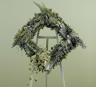Square Foliage Standing Spray - Our Square Foliage Standing Spray is a unique modern piece for a truly one-of-a-kind memorial tribute!   Approximately 36"h x 32"w   Depending on seasonal availabilty, substitutions may be made. Colors, style, and value will remain close to the general style and theme of the original arrangement   For Delivery to the following Funeral Homes, Mortuaries, and Crematories in East Moline and other Quad Cities: Van Hoe Funeral Home, Esterdahl Mortuary &amp; Crematory, Sullivan Ellis Mortuary, Schroder Mortuary, Wheelan Pressly Funeral Home, Rafferty Funeral Home, Trimble Funeral Home, DeRoo Funeral Home, Orr Mortuary, Knox Chapel, Wendt Funeral Home, McGinnis Chambers Funeral Home, Cunnick Collins Funeral Home, Runge Mortuary, Weert Funeral Home.