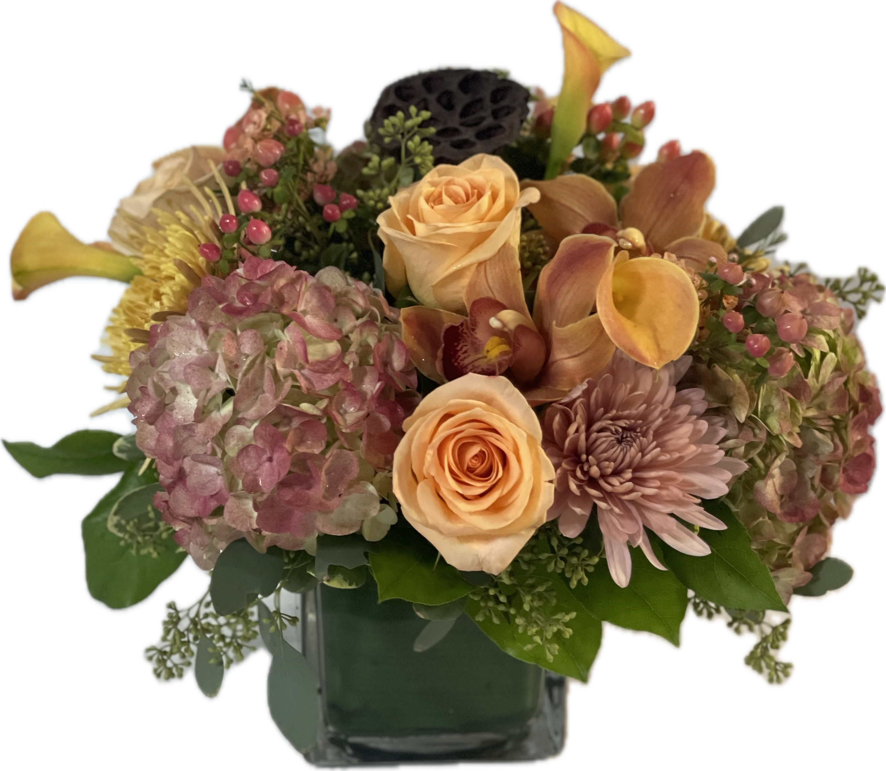 Peach roses and pink hydrangeas in a glass vase
