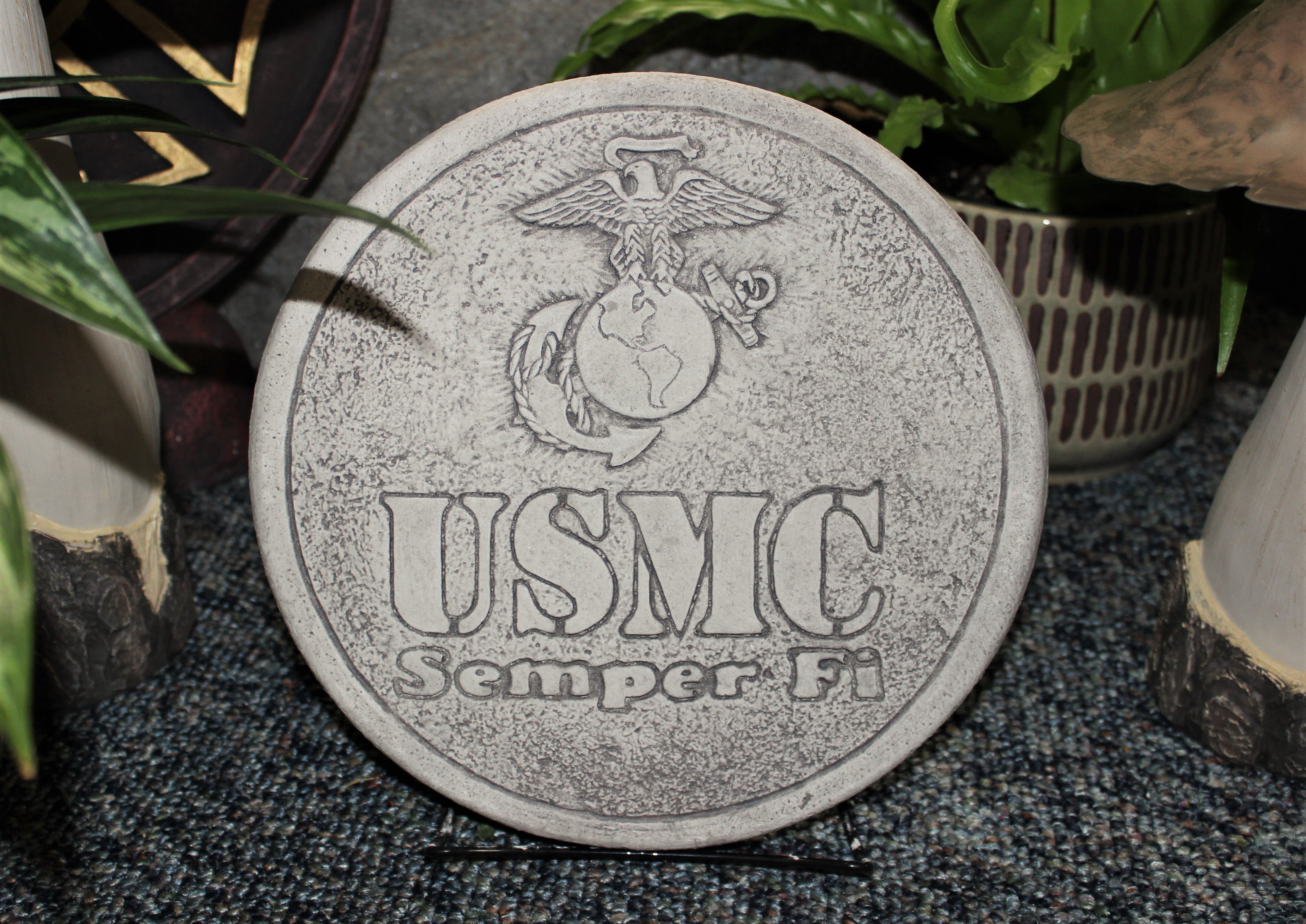 Round stone plaque engraved with the USMC emblem and text