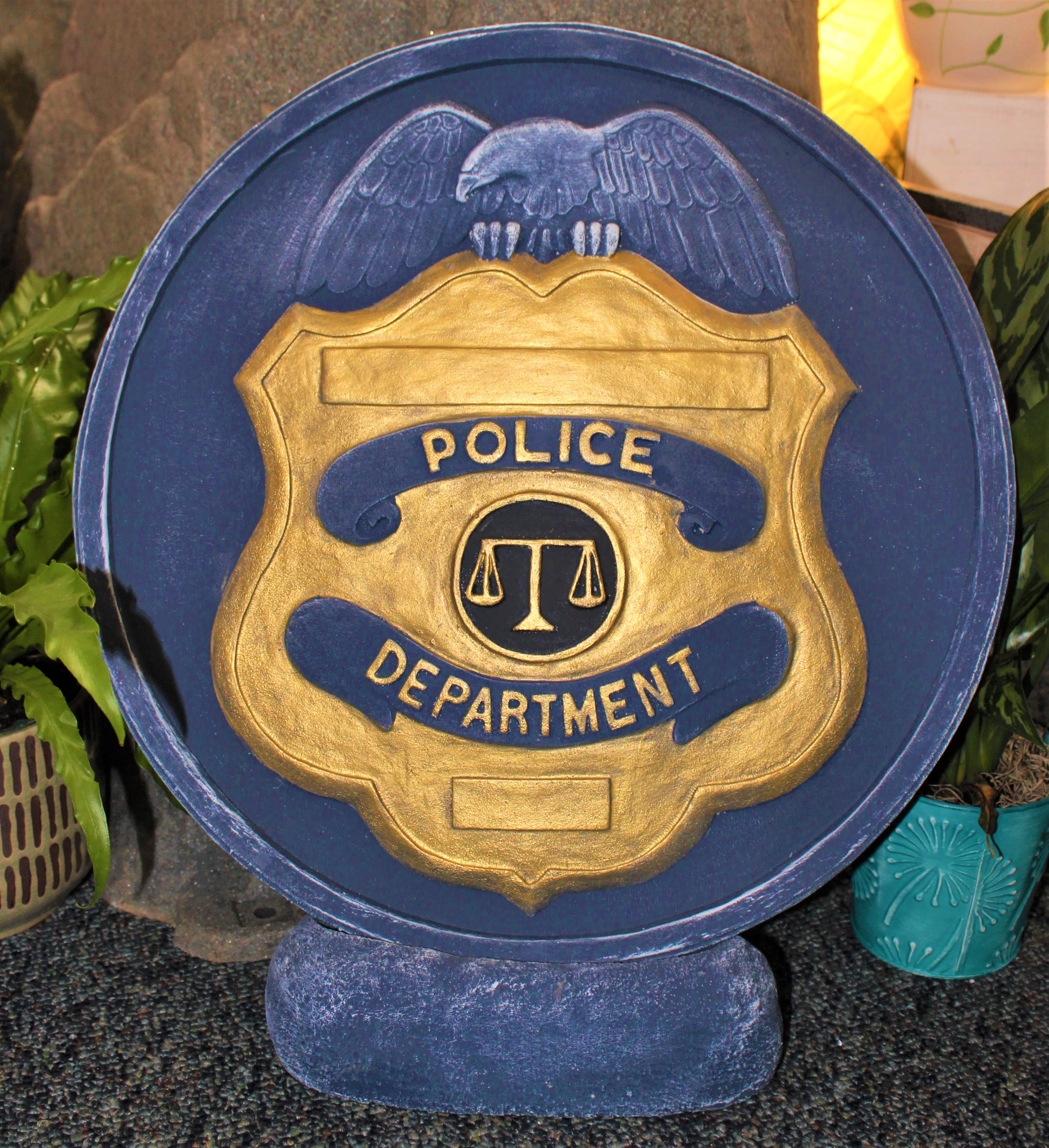 Blue and gold police department plaque with an eagle emblem