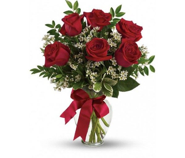 Red roses in a glass vase with a red ribbon