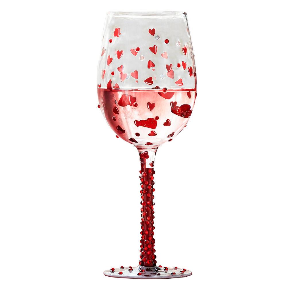 Clear wine glass decorated with red heart confetti