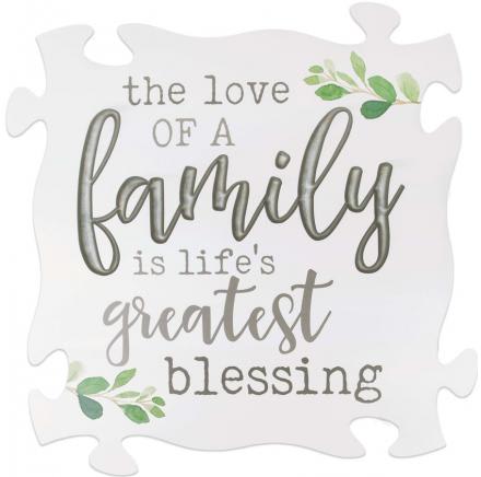 Decorative puzzle-piece sign with the words "the love of a family is life's greatest blessing"