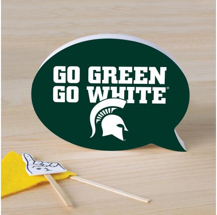 Green speech bubble sign with white text and a small yellow pennant