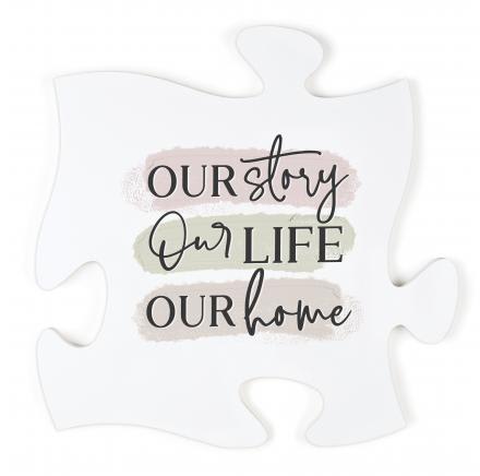White puzzle piece sign with the words "Our story Our life Our home"