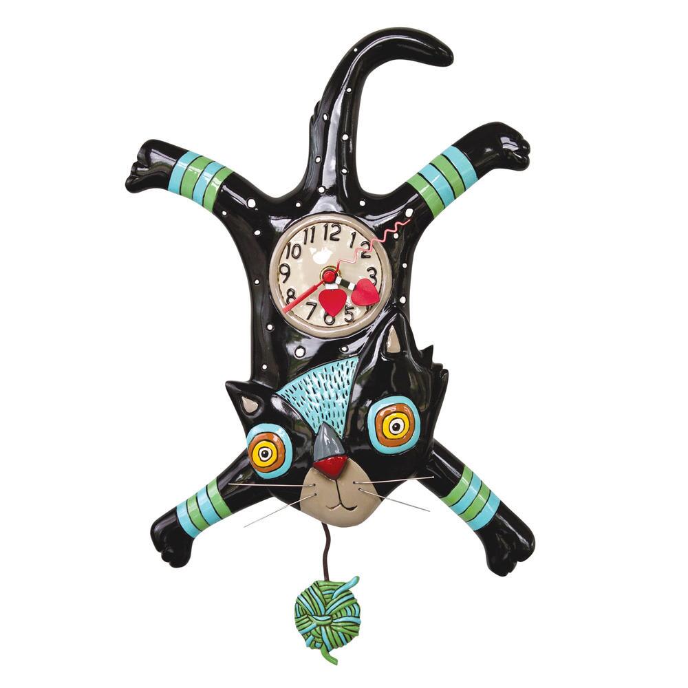 Black cat-shaped wall clock with colorful striped accents and a dangling yarn ball