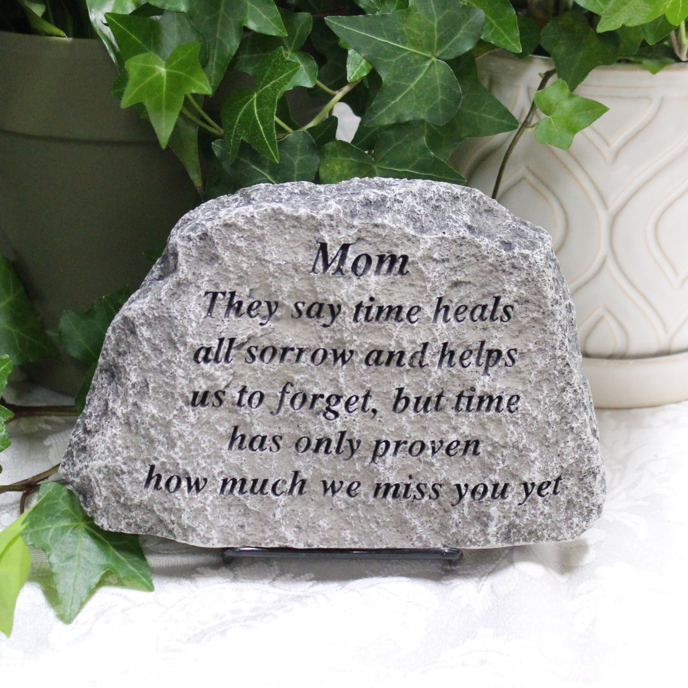 Engraved memorial stone with ivy leaves and a sympathy message for Mom