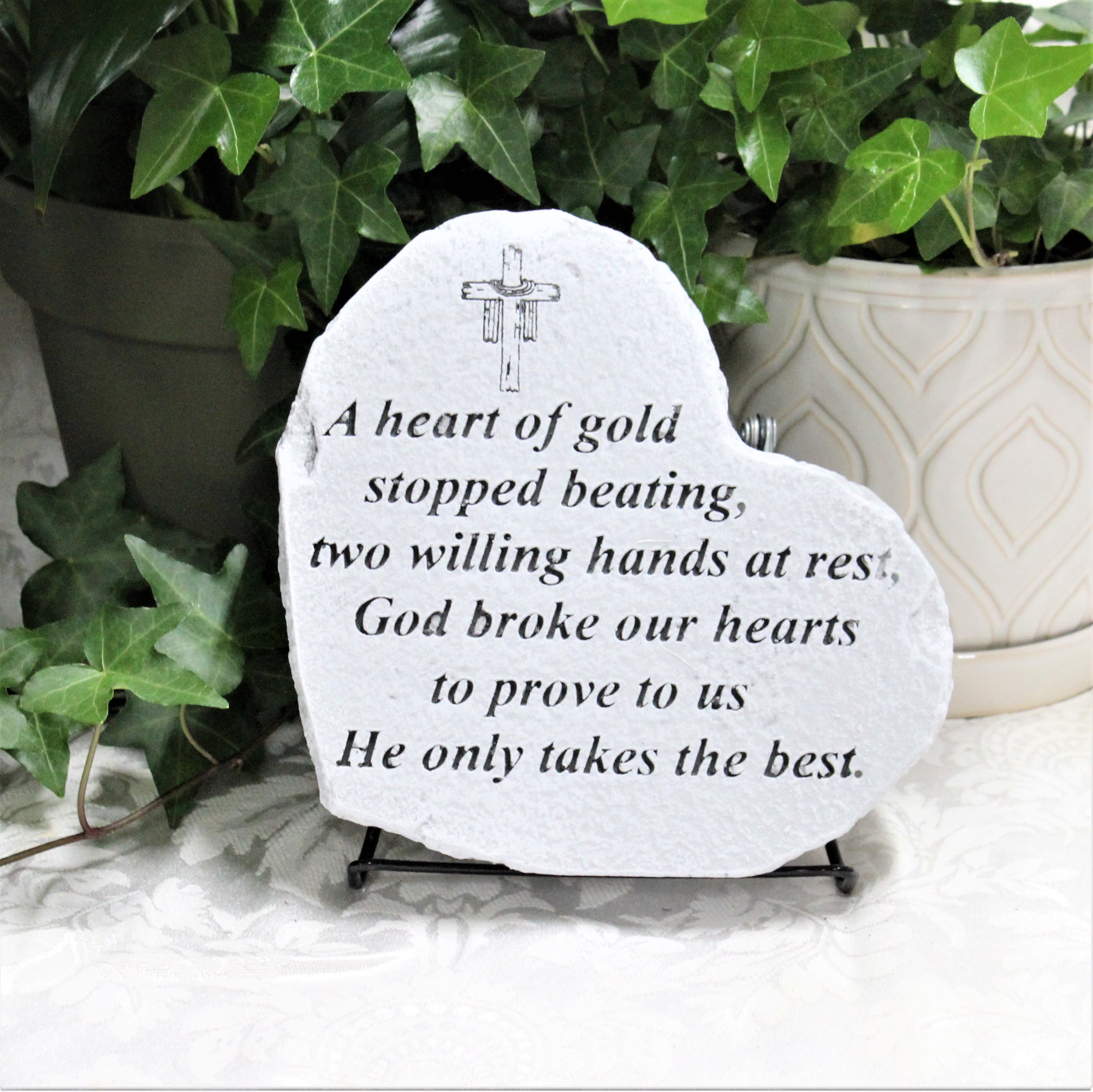 Heart-shaped memorial stone with a printed sympathy verse on a stand