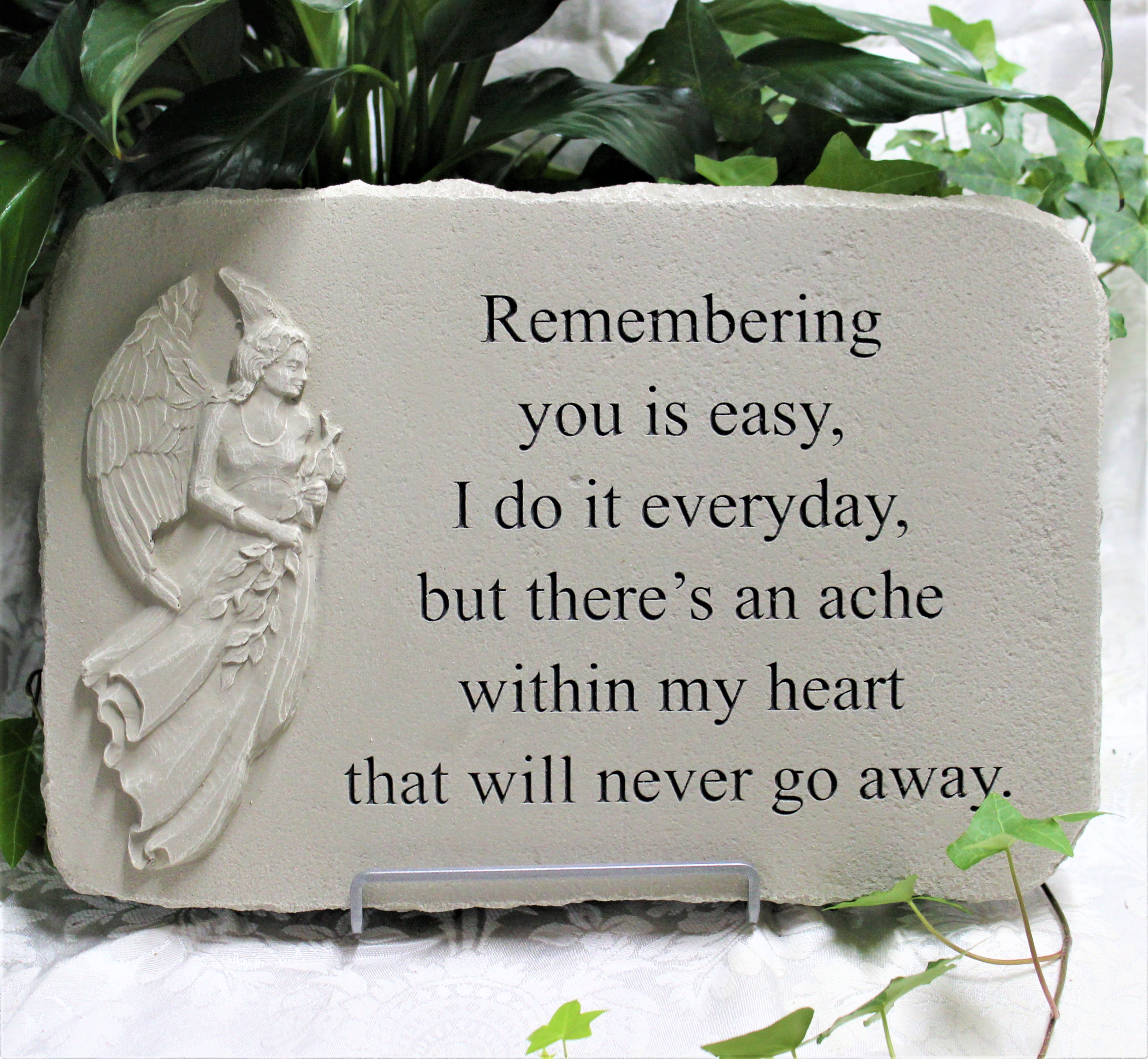 Memorial stone plaque with an angel relief and engraved text