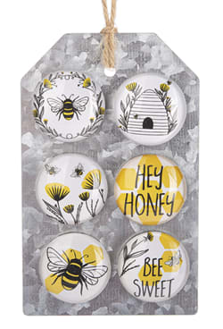 Set of six bee-themed decorative magnets on a hanging board