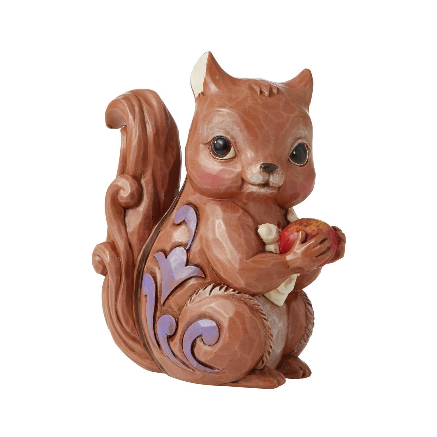 Decorative squirrel figurine holding an apple