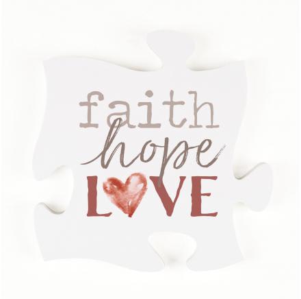White decorative pillow with the words faith hope love