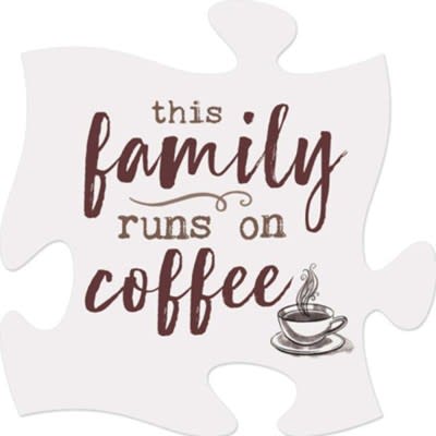 Puzzle-piece sign reading "this family runs on coffee" with a cup graphic