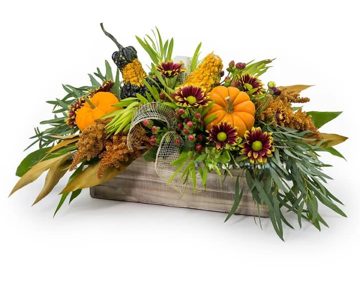 Autumn floral arrangement with pumpkins in a wooden box