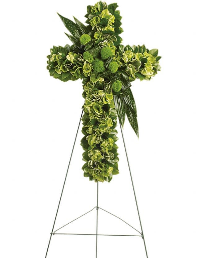 Green floral cross on a metal easel