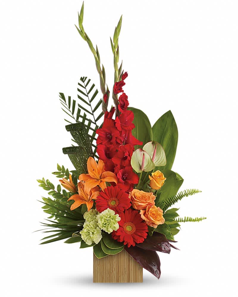 Tropical flower arrangement with red, orange, and green blooms in a wooden container