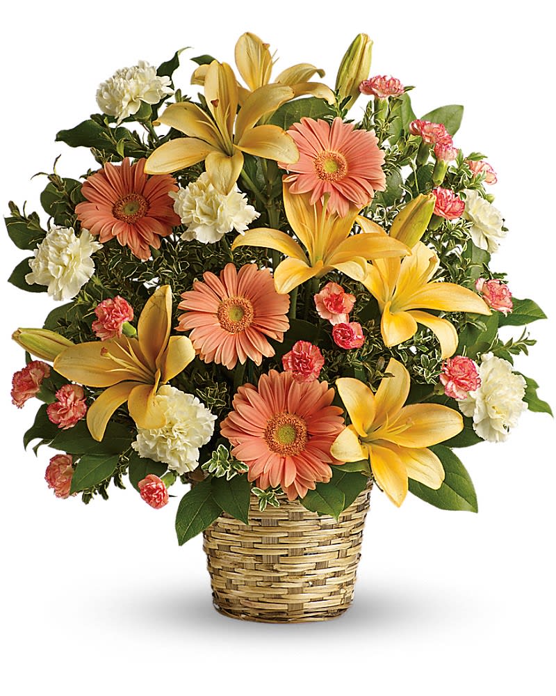 Basket arrangement of yellow lilies, peach gerberas, and white carnations