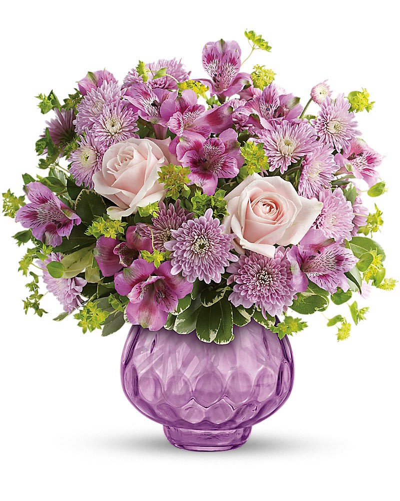 Pink roses and purple flowers arranged in a purple glass vase