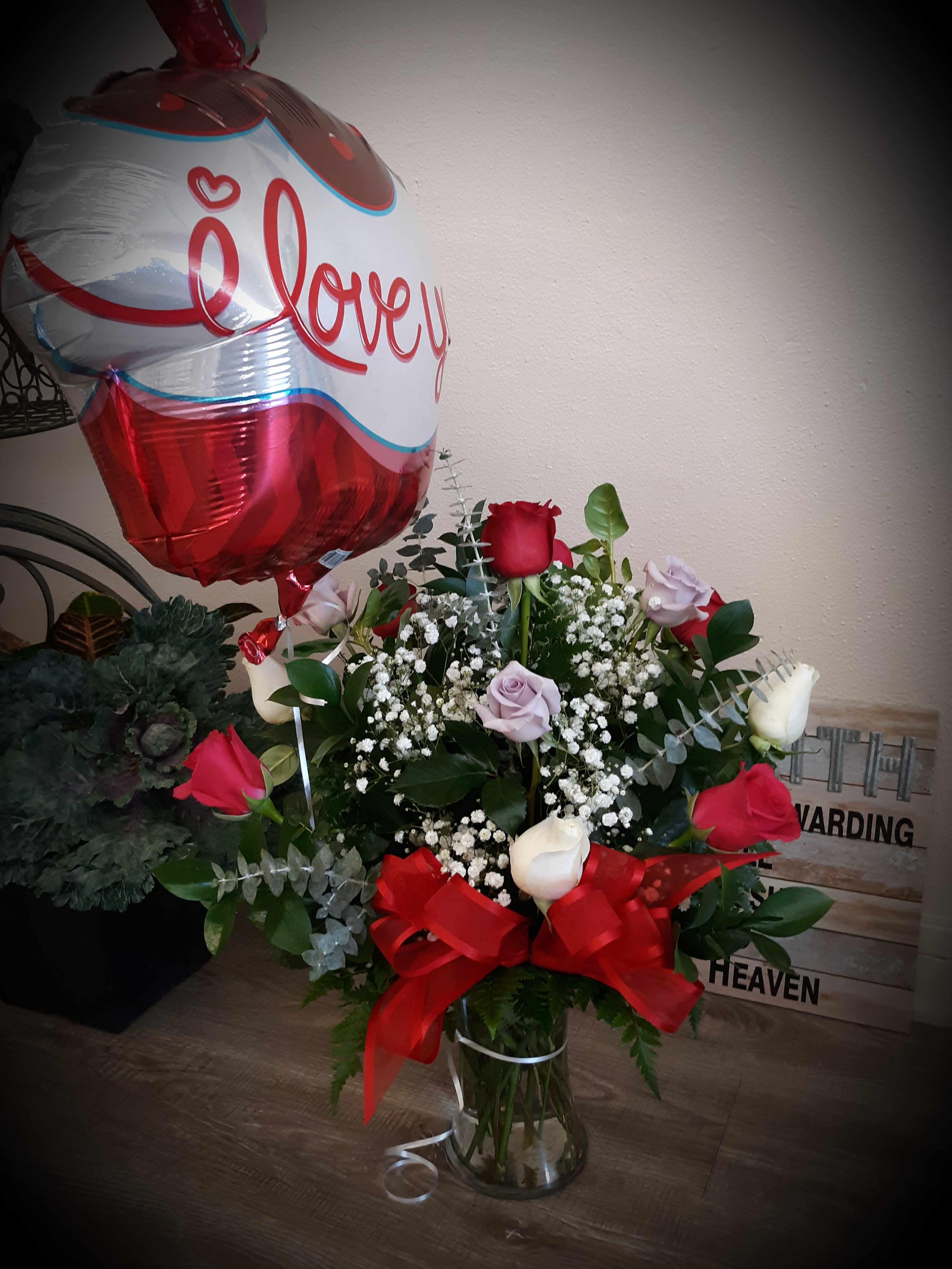 Bouquet of red and white roses with a heart balloon