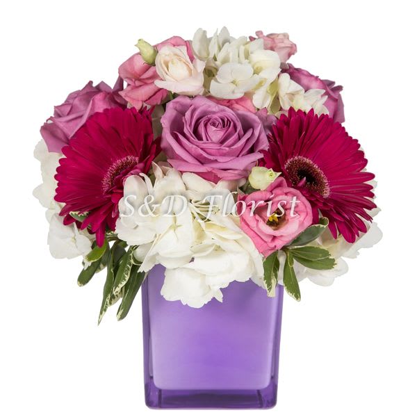 Pink and white mixed bouquet in a purple vase