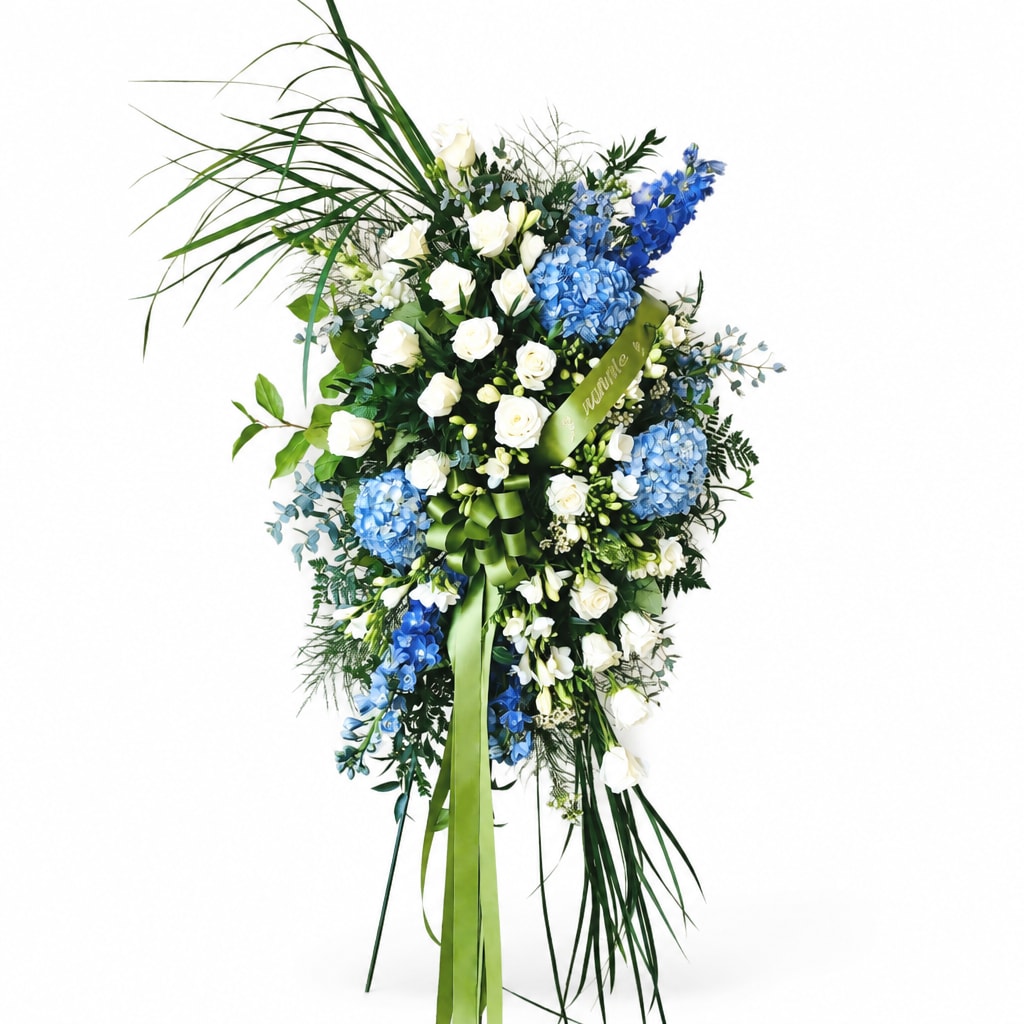 Tall blue and white floral spray with ribbon on a white background