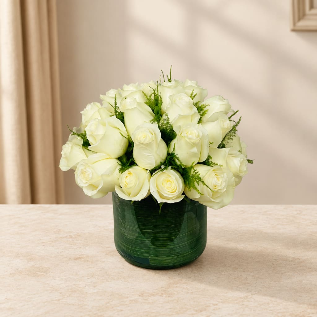 White rose bouquet in a green glass vase