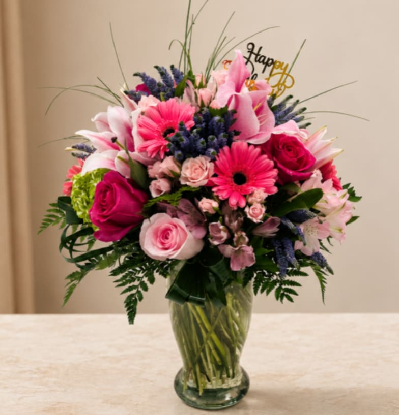 Pink and purple mixed bouquet in a clear glass vase