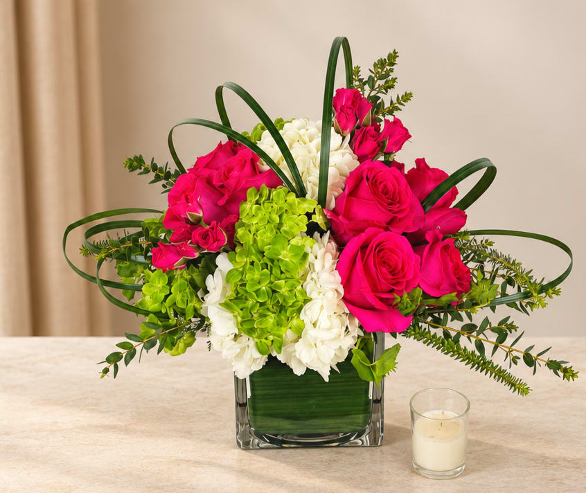 Pink roses and white hydrangeas in a square glass vase