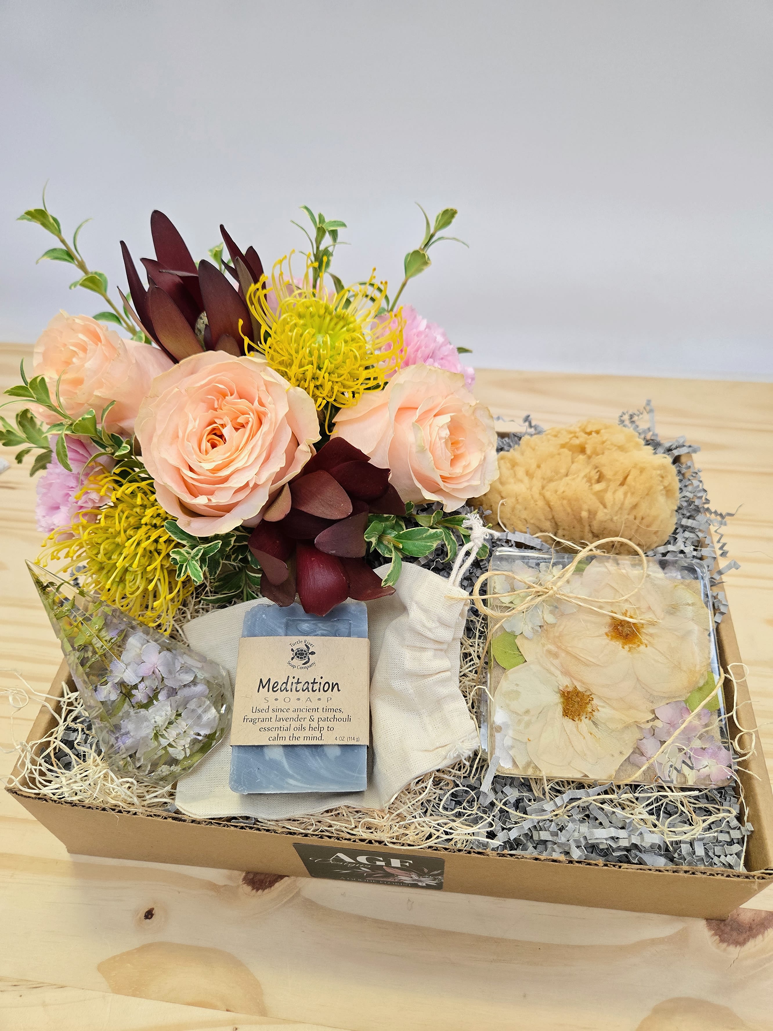 Gift box with peach roses, yellow flowers, soap, and dried floral accents
