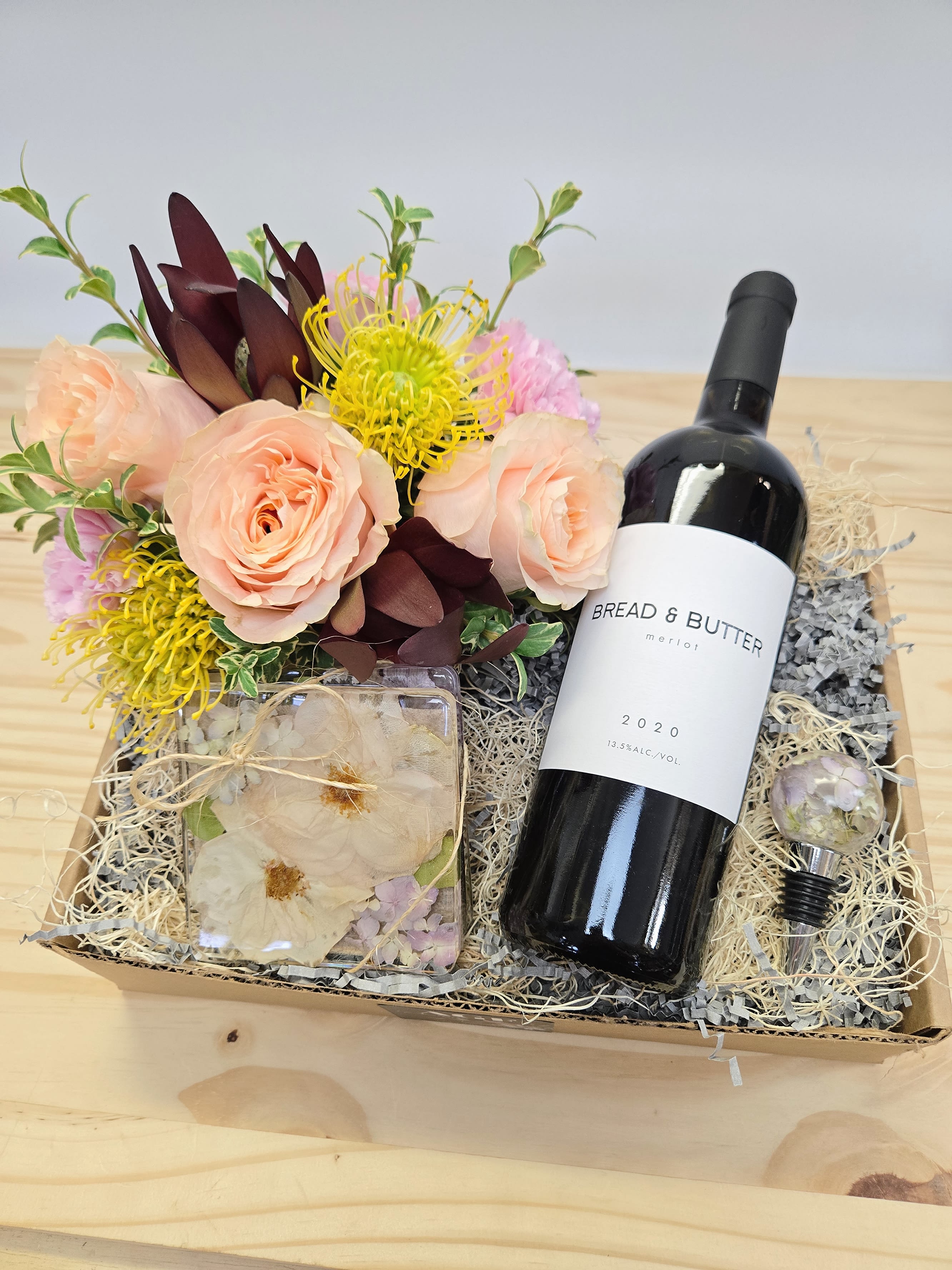 Gift box with roses and a wine bottle