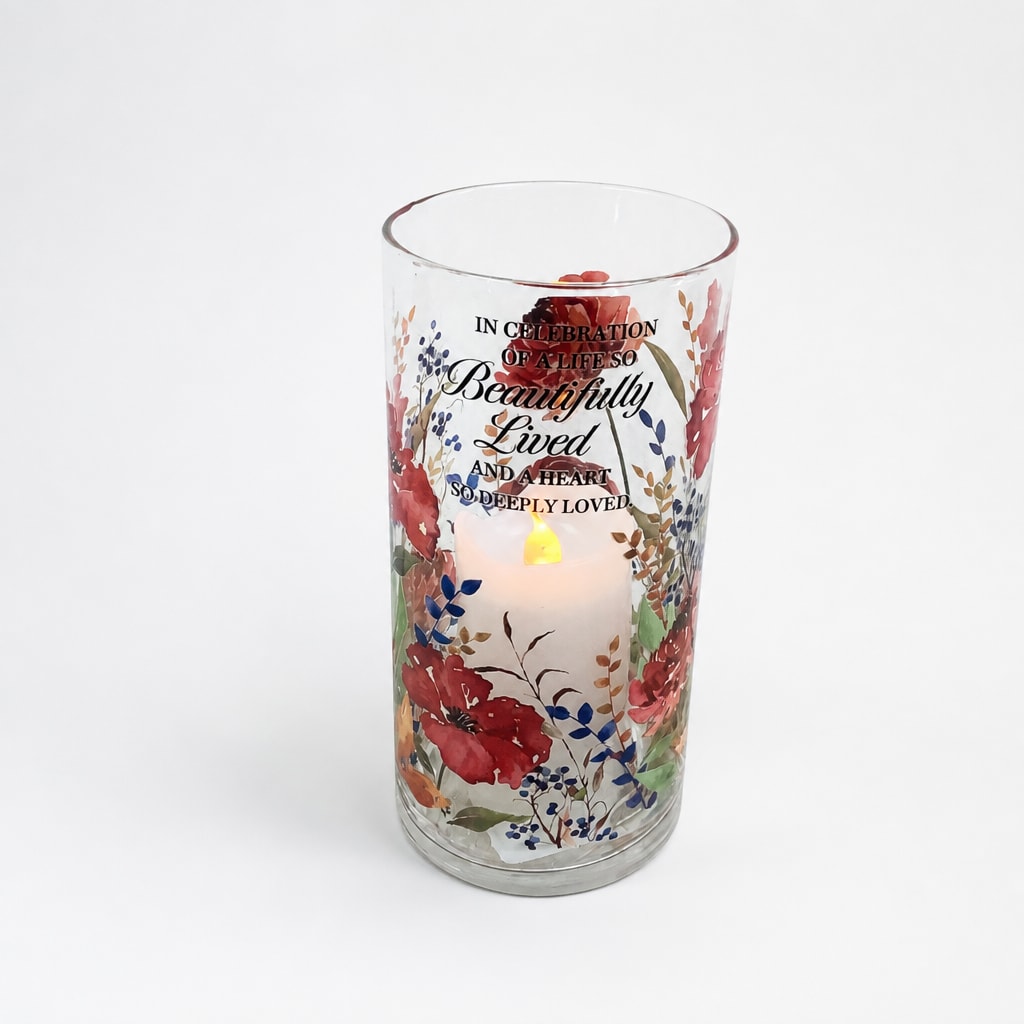 Glass memorial candle holder with floral print and lit candle