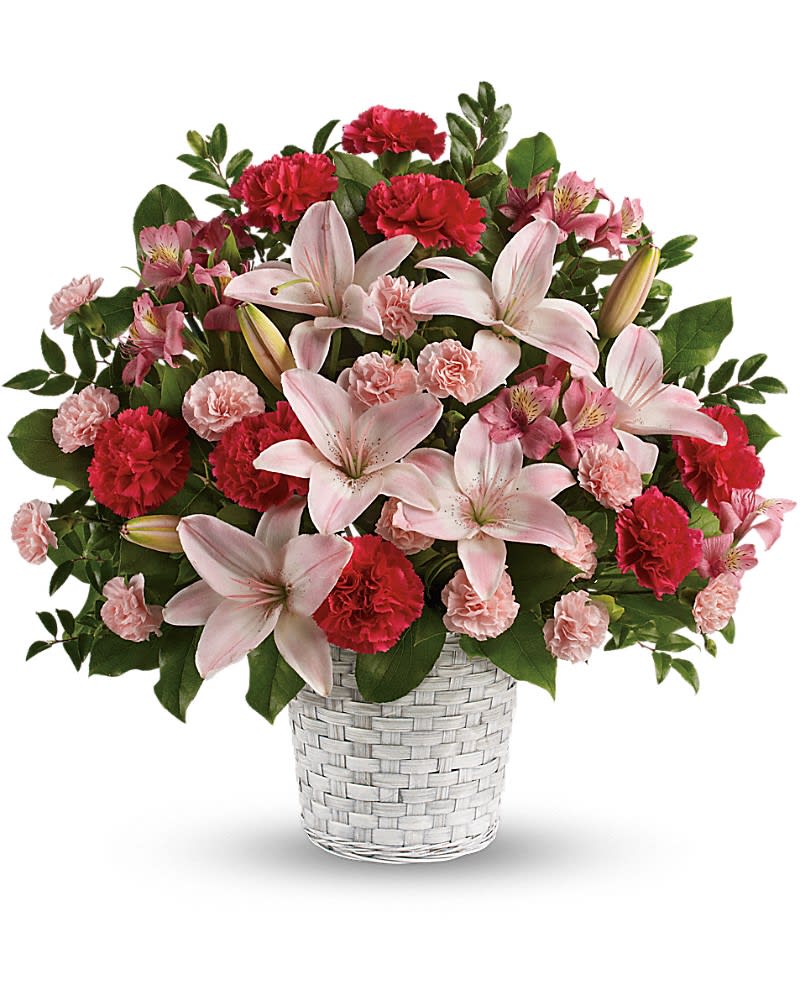 Pink lilies and red carnations in a white woven basket