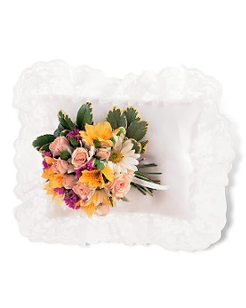 Bouquet of mixed flowers on a white pillow