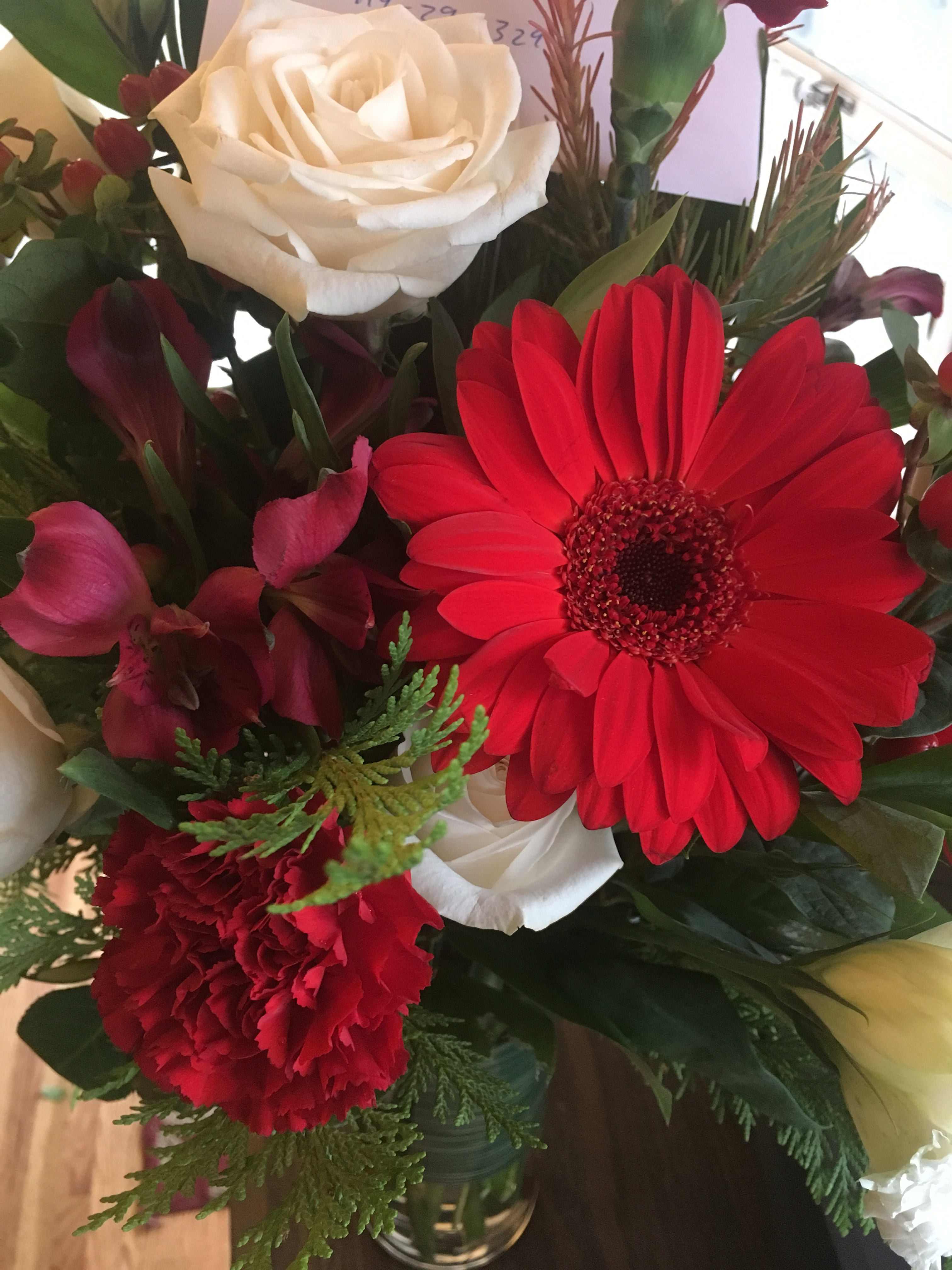 Bouquet of red gerbera daisies, white roses, and red carnations
