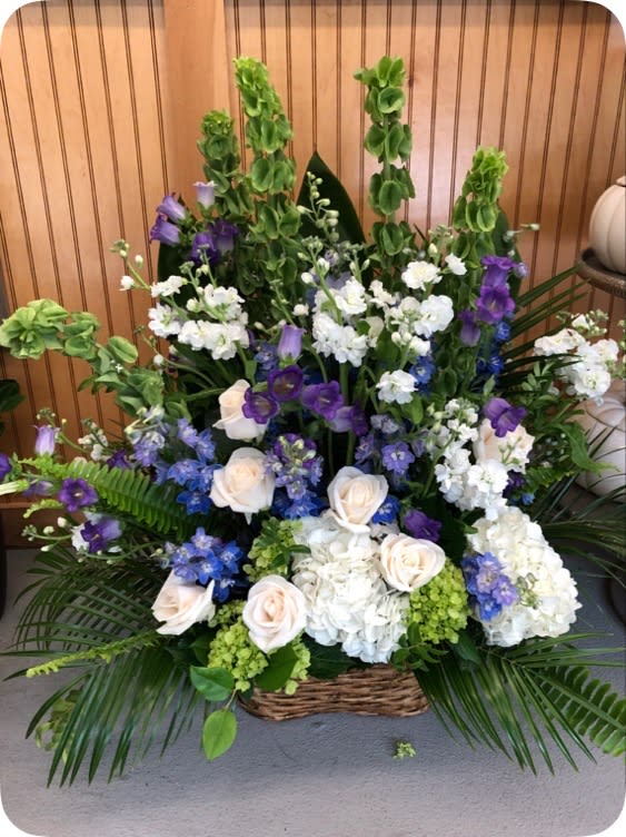 Large basket arrangement of white, purple, and blue flowers
