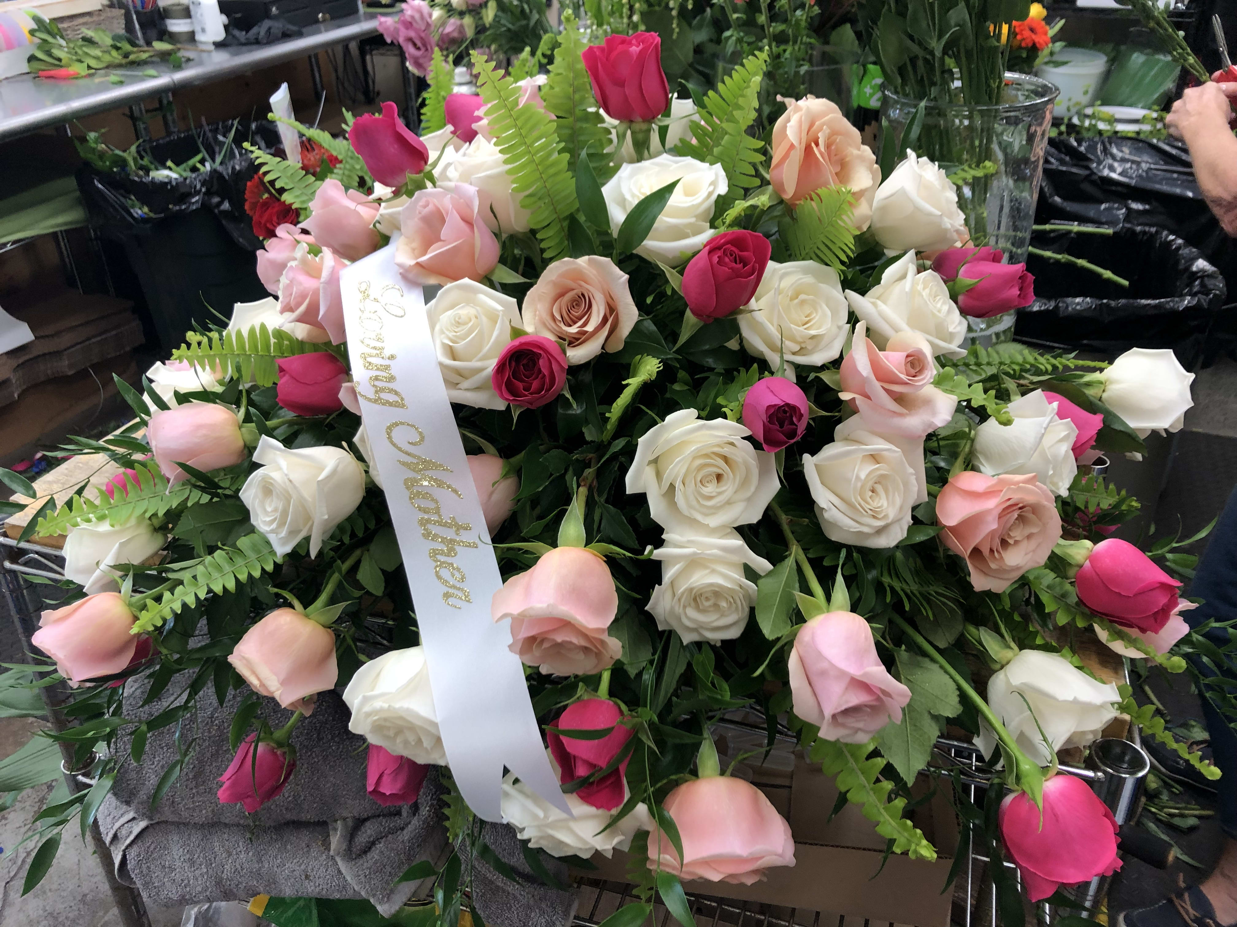 Large bouquet of pink and white roses with a ribbon